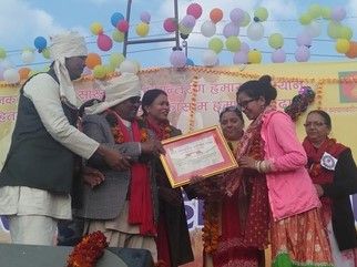 Bishnu Chaudhary receives an award for her activism at Maghe Sankranti 2020.