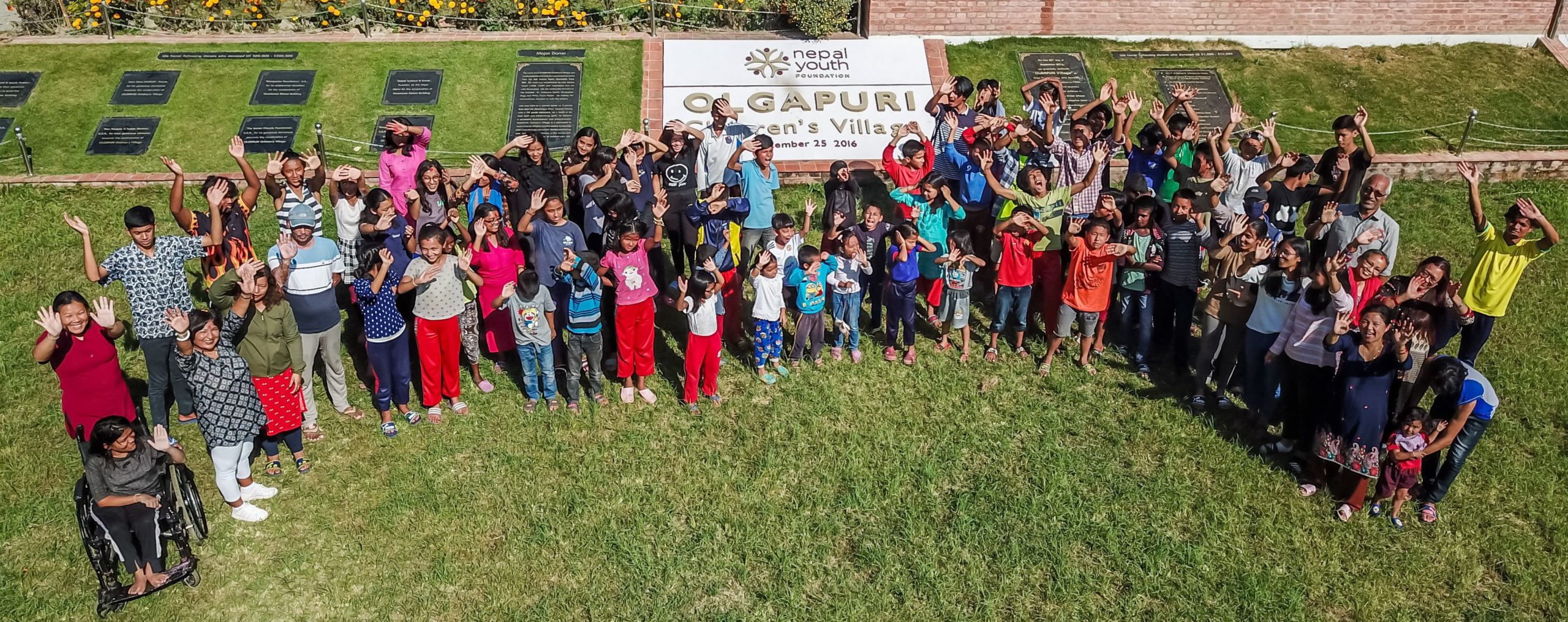 The children of Olgapuri pose on the front lawn in 2020.