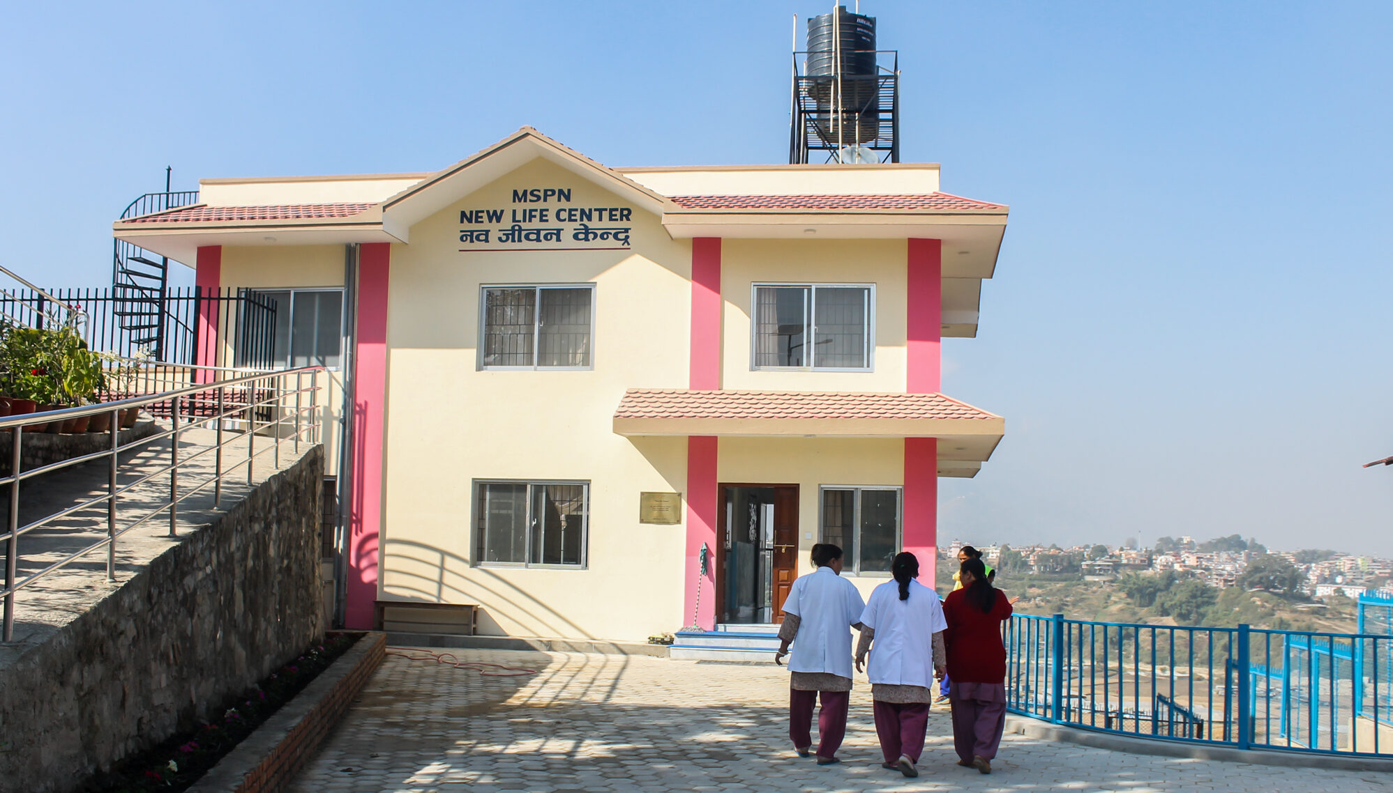 Staff at the New Life Center are pictured walking towards the building.