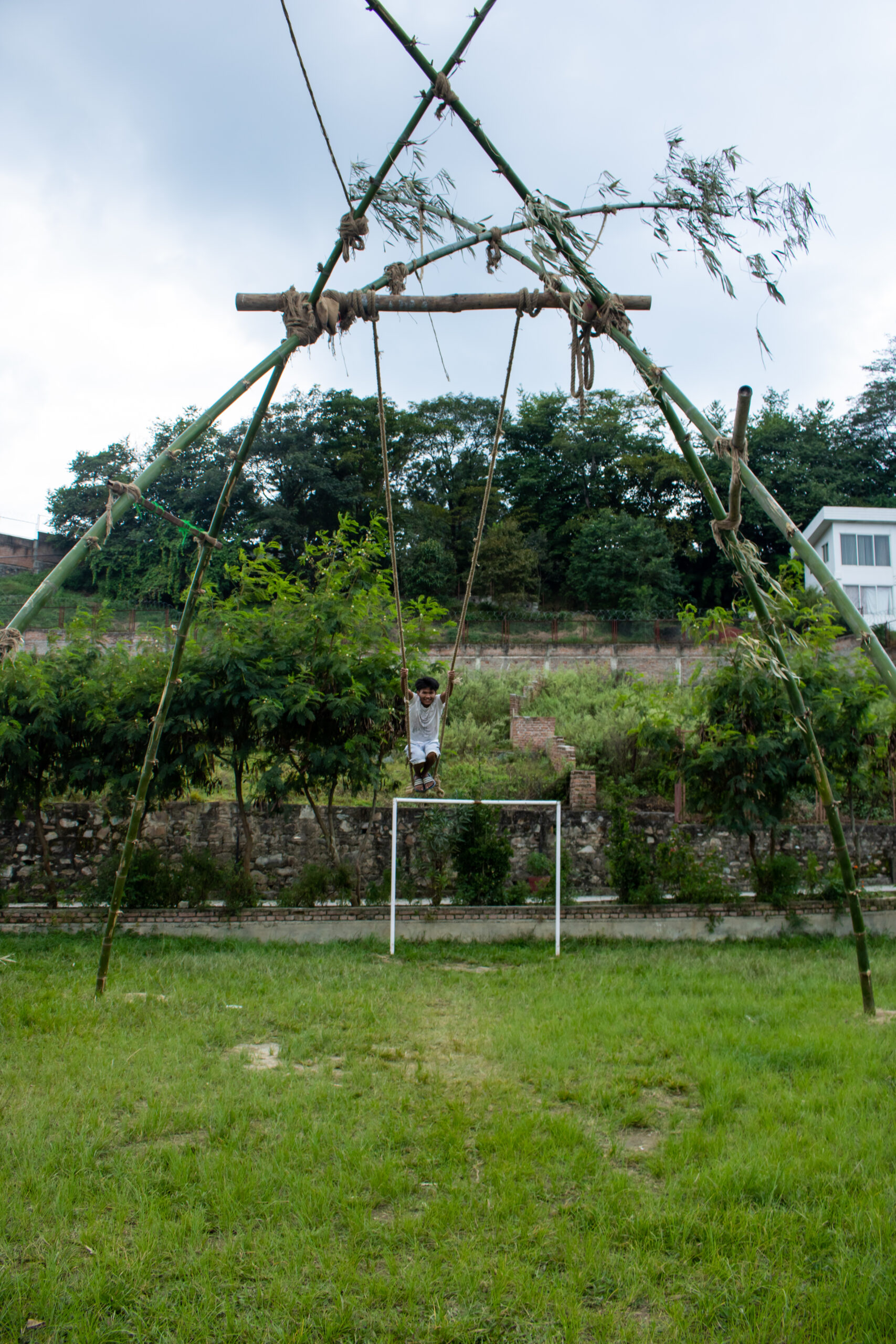 A junior boy at Olgapuri swings on the linge ping. 